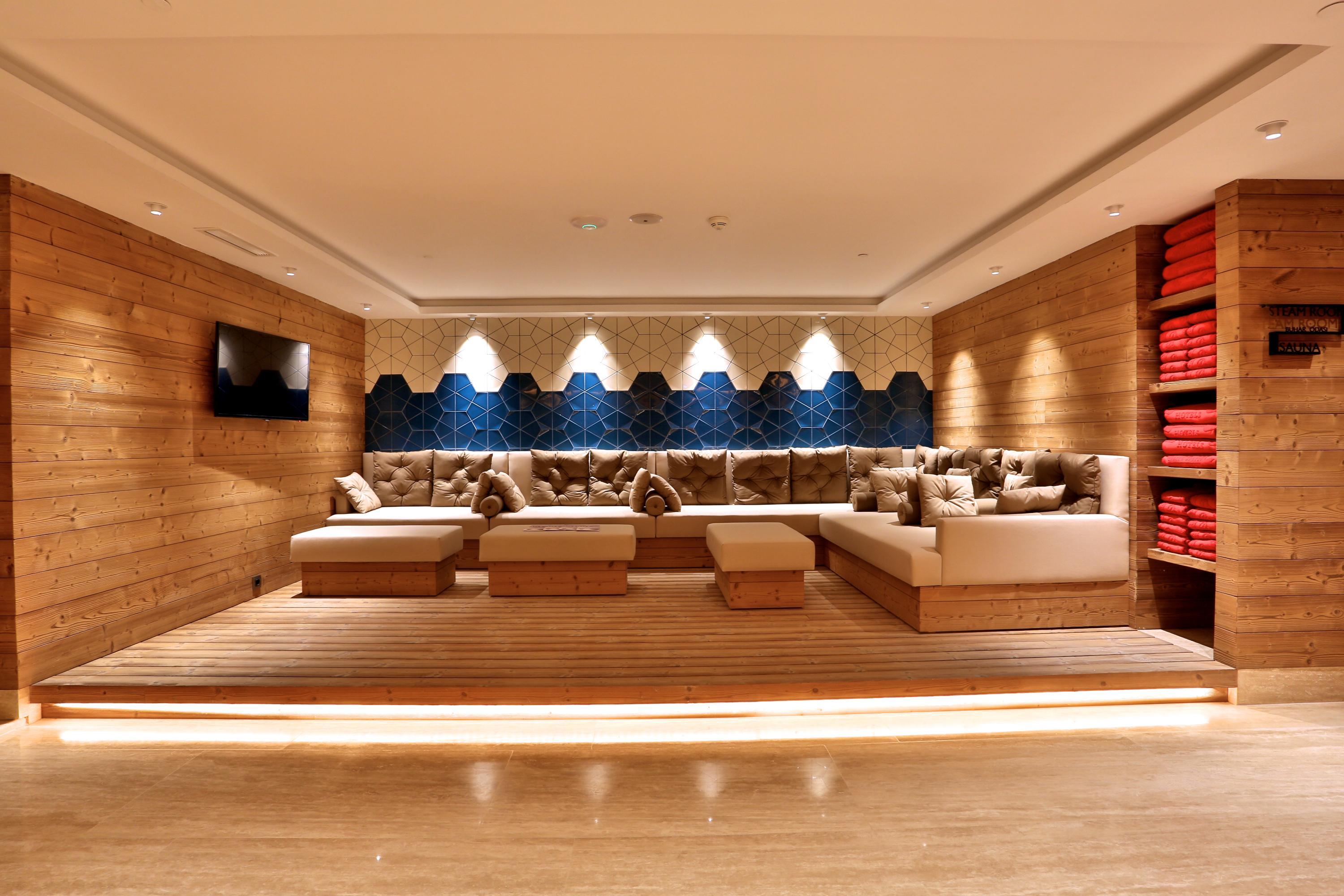Dosso Dossi Hotels & Spa Downtown Istanbul Ngoại thất bức ảnh The photo shows a cozy and modern lounge or relaxation area. It features wooden walls and a light-colored wooden floor, creating a warm atmosphere. The seating consists of plush couches with decorative cushions in neutral tones, arranged around a low
